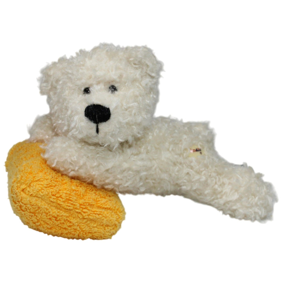 Süßer Teddybär auf gelbem Kissen