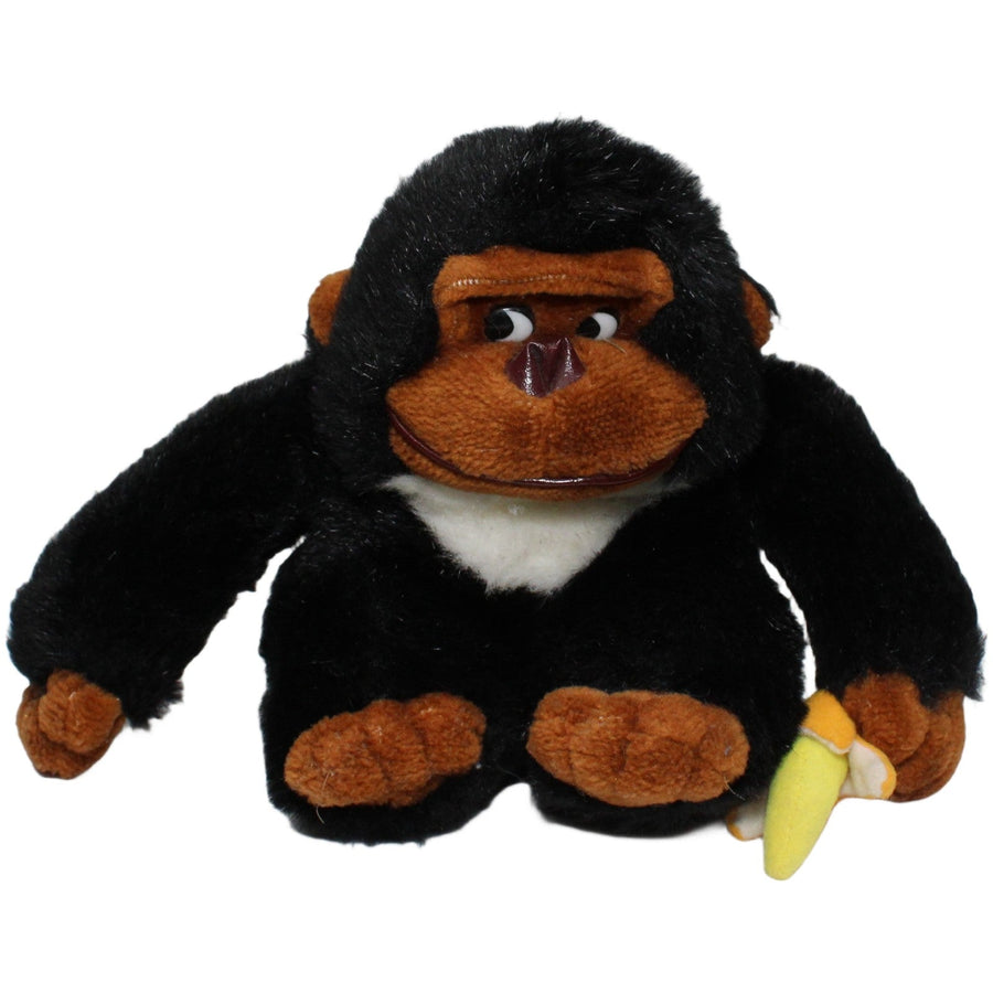 Süßer Gorilla mit Banane, sitzend