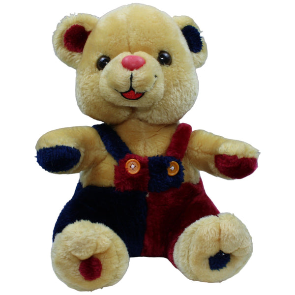 Lachender Teddybär mit bunter Latzhose