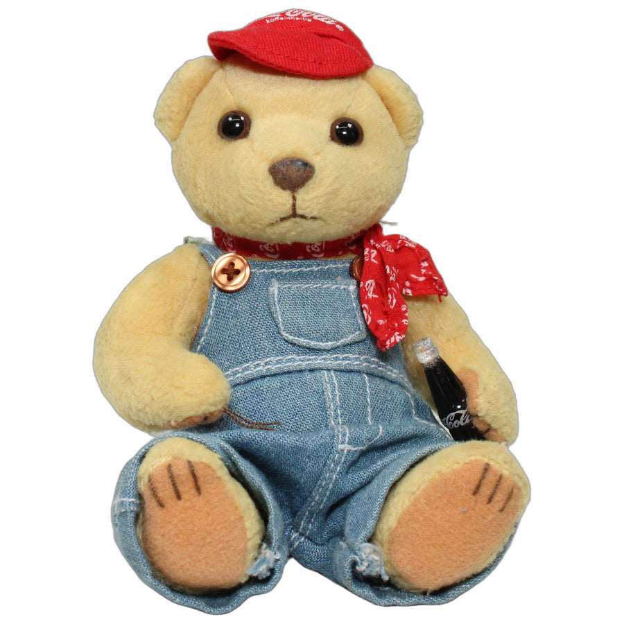 Beiger Coca Cola Teddy mit Kappe in Latzhose